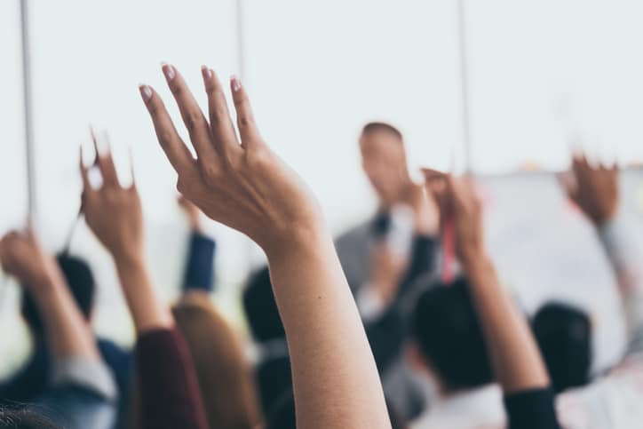 Audience raising hands during a speech